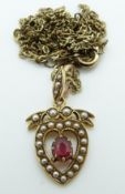 An Edwardian 15ct gold pendant set with a ruby and seed pearls in a heart shape