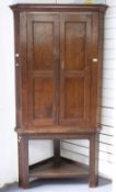 A 19thC oak corner cupboard on stand H186cm