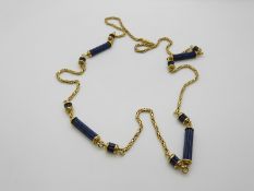 An 18ct gold necklace set with reeded column sections of lapis lazuli, 55.