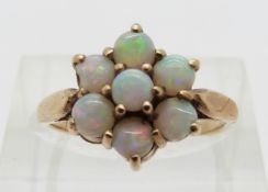 A 9ct gold ring set with a cluster of opal cabochons,