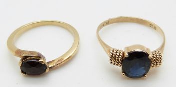 A 14ct gold ring set with a sapphire and a yellow metal ring set with a garnet