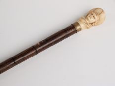 A 19thC bamboo and carved ivory bust, possibly Kate Greenaway-style figure,