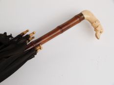 Late 19thC/20thC parasol with carved ivory handle in the form of a dog/greyhound on bamboo stick,