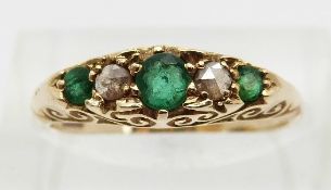 Edwardian 15ct gold ring set with three emeralds and two rose cut diamonds,