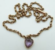 A 9ct rose gold chain with a Victorian pendant set with a heart cut amethyst, 6.