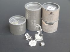 Four Sworovski Crystal cut glass figure groups comprising Seahorse, Ladybird, Seal Pup and Hedgehog,