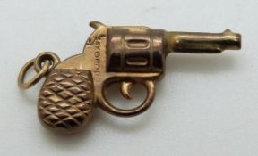 A 9ct gold charm in the form of a revolver,