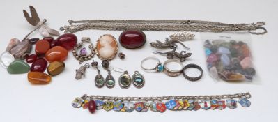 A white metal charm bracelet, silver rings, agate, cherry amber brooch,