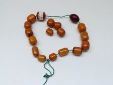 An amber necklace made up of barrel shaped beads