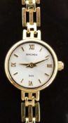 Sekonda 9ct gold ladies wristwatch with gold hands, Roman numerals, baton markers and silver face,