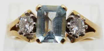 An 18ct gold ring set with an emerald cut aquamarine of approximately 1ct and two diamonds,