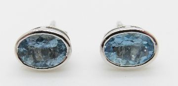 A pair of 9ct white gold earrings set with an oval aquamarine to each