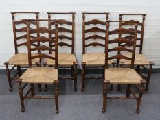 Six ladder back rush seated country dining chairs with turned top rail