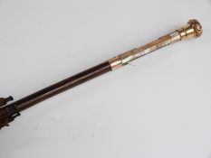 A late 19thC/20thC parasol with 15ct gold handle and collar and hardwood stick,