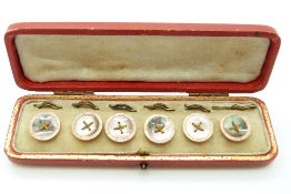 A boxed set of yellow metal buttons set with abalone