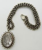 Victorian locket with engraved foliate design,