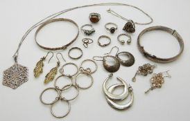A collection of silver jewellery including two bangles, seven rings, two pairs of filigree earrings,