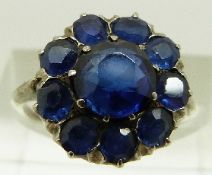 A white metal ring set with a cluster of natural and synthetic sapphires, size G, 3.