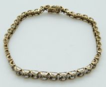 A 9ct gold tennis bracelet set with diamonds, 7.