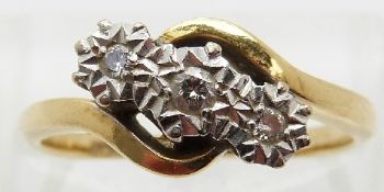 An 18ct gold ring set with three diamonds in a platinum illusion setting,