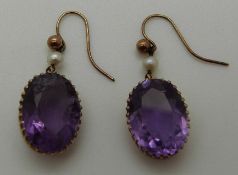A pair of late Victorian / early Edwardian earrings set with amethyst and a pearl,