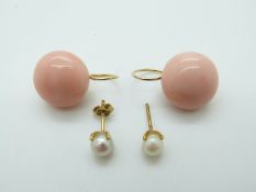 A pair of 18ct gold earrings set with a pearl to each and a pair of yellow metal earrings each set