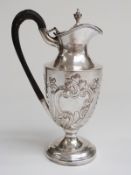 Victorian hallmarked silver pedestal hot water jug with embossed decoration,