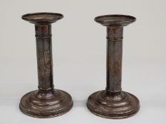 Pair of white metal candlesticks marked sterling, height 14cm,