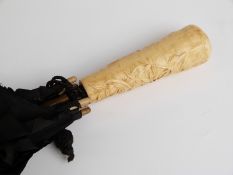 A 19thC/20thC parasol with faux ivory handle,