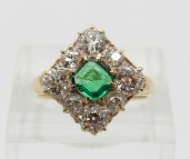 A late Victorian/ early Edwardian ring set with a square step cut emerald of approximately 0.