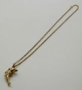 A 9ct gold articulated pendant in the form of a dolphin set with paste on a 9ct gold chain, 7.