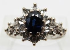 An 18ct white gold ring set wth an oval sapphire and diamonds,