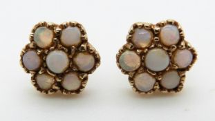 A pair of 9ct gold earrings set with a cluster of opals