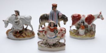 Four Staffordshire figures including milkmaids,