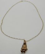 A 9ct gold pendant in the form of a clown set with paste and a 9ct gold chain, 7.