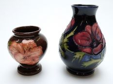Two Moorcroft pedestal vases in Hibiscus and Clematis patterns,