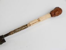 Victorian/Edwardian parasol with intricately carved wooden bust handle, possibly Asian/Oriental,