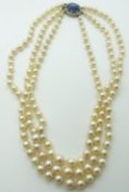 A three-strand pearl necklace,