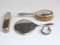 Mappin & Webb three piece hallmarked silver dressing table set and an Egyptian white metal bangle,