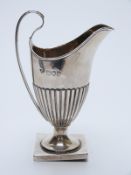 Victorian hallmarked silver helmet shaped cream jug with reeded lower section,