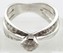 A 14ct white gold ring set with a round brilliant cut diamond of approximately 0.