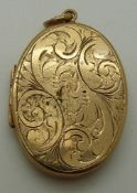 A 9ct gold locket with foliate decoration, 9.