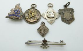 A hallmarked silver bowls medallion, two silver fobs,