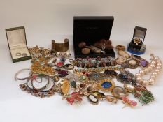 A collection of costume jewellery including two white metal bangles, Victorian mourning brooch,