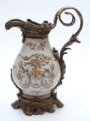 A large ceramic jug with brass fittings,