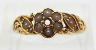 An 18ct gold ring set with seed pearls,