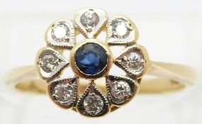 An 18ct gold ring set with a sapphire surrounded by diamonds,