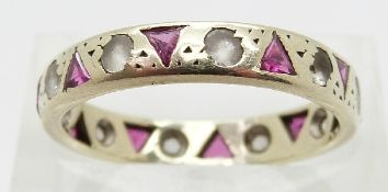 A 9ct white gold eternity ring set with rubies and paste,