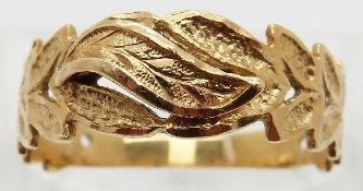 A yellow metal ring in a foliate design with textured surface, size Q, 2.