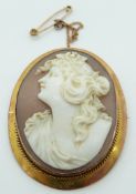 A 9ct gold brooch set with a shell cameo depicting a young woman, 3.7 x 4.